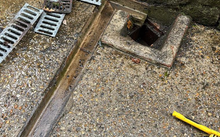 Channel drain grates lifted for clearing