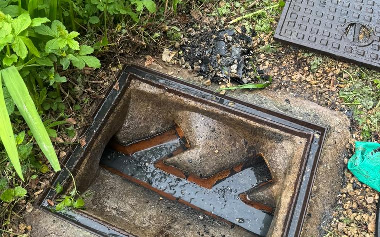 Drain chamber opened up showing pipework and benching