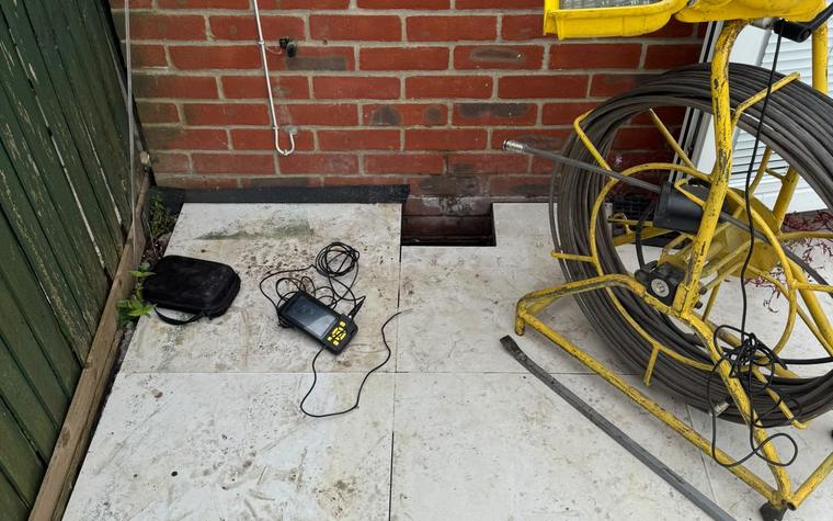 Drain rod and hose reel set up at a rear alley job