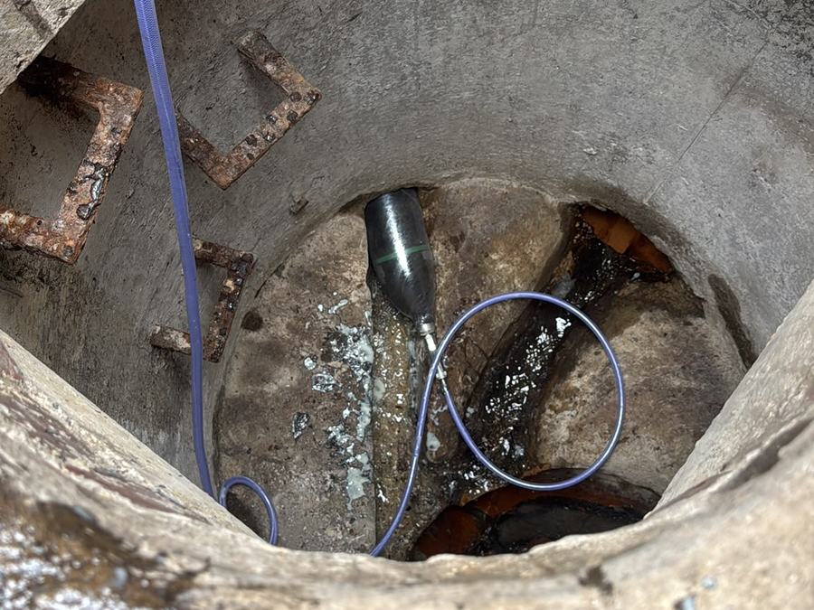 Survey camera lowered into a brick drainage chamber