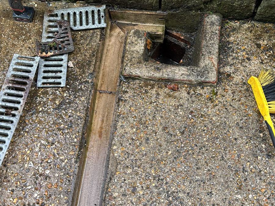 Channel drain grates lifted and the channel cleared