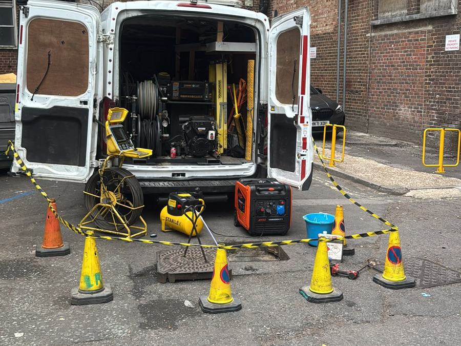 Drainage van and cones set up on a commercial callout