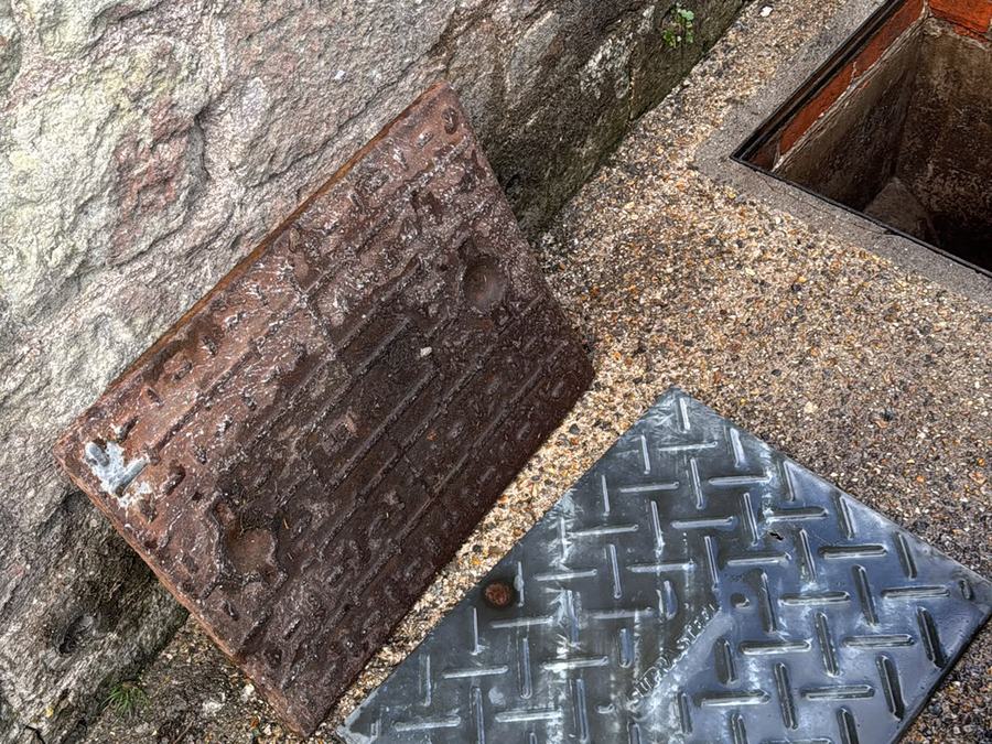 Manhole cover lifted to check the chamber below
